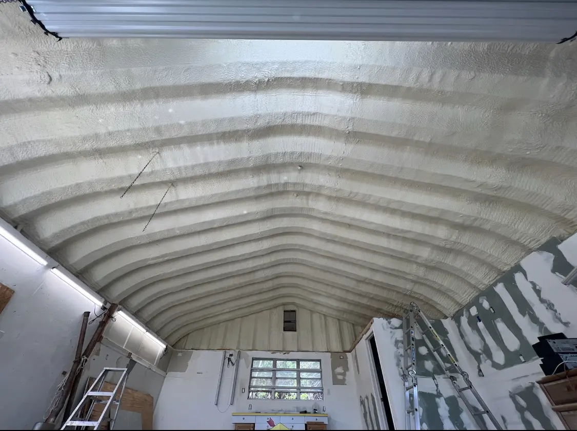 Spray polyurethane foam applied to the underside of a metal roof deck in Abilene